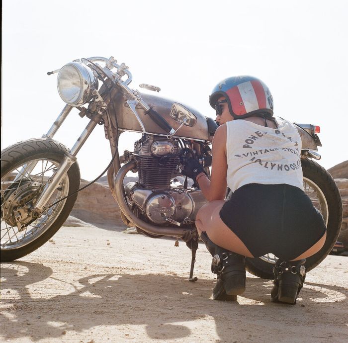 A playful frame from Girls on a motorcycle — online in Karachi